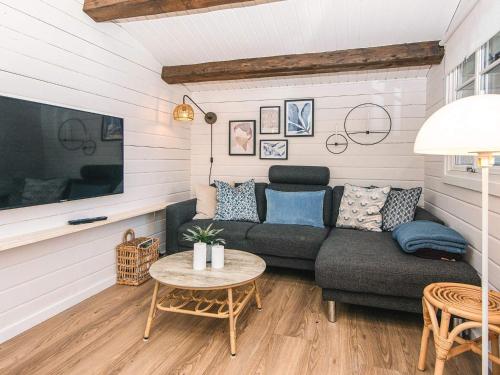 a living room with a couch and a table at 4 star holiday home in Hemmet in Hemmet