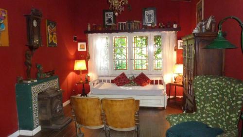 a bedroom with a bed and a window and chairs at Casa de campo Miramar Norte in Miramar