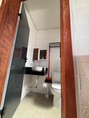 a small bathroom with a toilet and a sink at Chalés Champion Capitolio in Capitólio