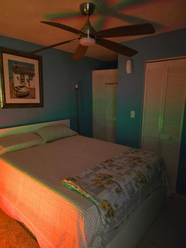 a bedroom with a bed with a ceiling fan at Healing Minds Home in Miramar