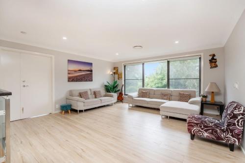 a living room with two couches and a fireplace at Charming 3-Bed Getaway with Pool & Garden Oasis in Lyons