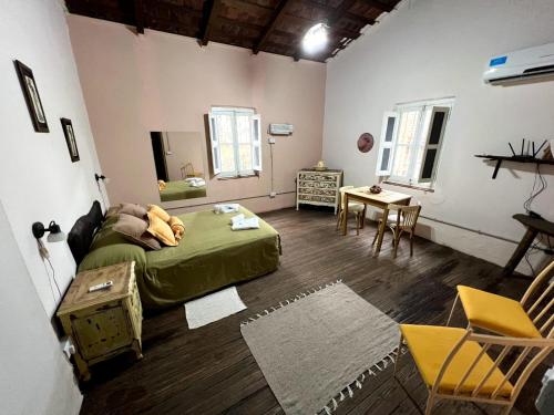 a room with a bed and a table and chairs at El Trébol Casa de Campo in Naicó