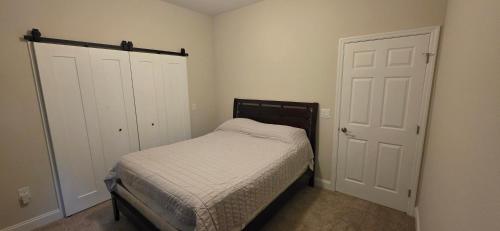 a small bedroom with a bed and a closet at Room in Downtown Orlando! Close to everything! in Orlando