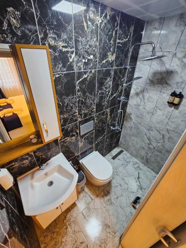 a bathroom with a sink and a toilet at yomra apart otel in Yomra