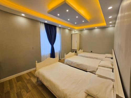 a room with two beds and a window at yomra apart otel in Yomra