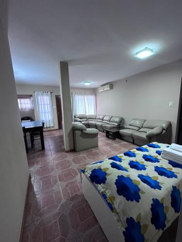 a bedroom with a bed and a living room at Casa nueva centrica in San Rafael
