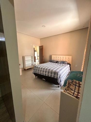 a bedroom with a bed with a checkered blanket at New progress, it's Félix! in Marabá