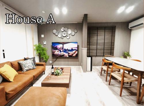 a living room with a couch and a table at HOTEL StayLuck KOTOHIRA - 琴平駅徒歩4分 in Kotohira