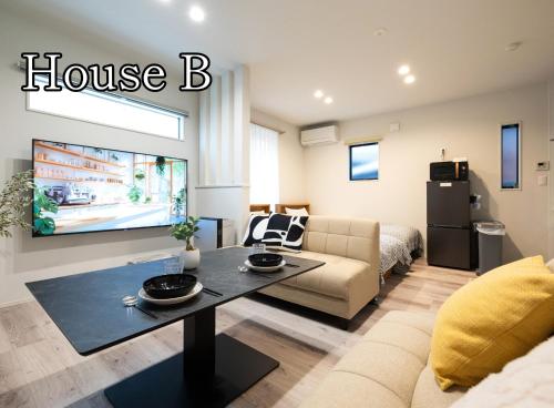 a living room with a couch and a tv at HOTEL StayLuck KOTOHIRA - 琴平駅徒歩4分 in Kotohira