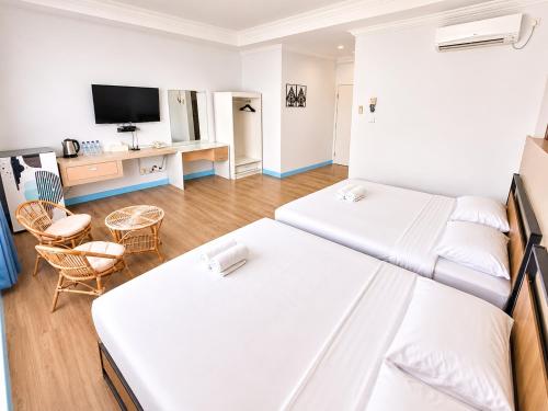 a hotel room with two beds and a tv at Allisa Resort Hotel in Anyer