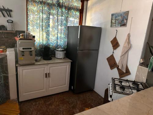 a kitchen with a refrigerator and a counter with a microwave at Kukuriaz Fare in Bora Bora