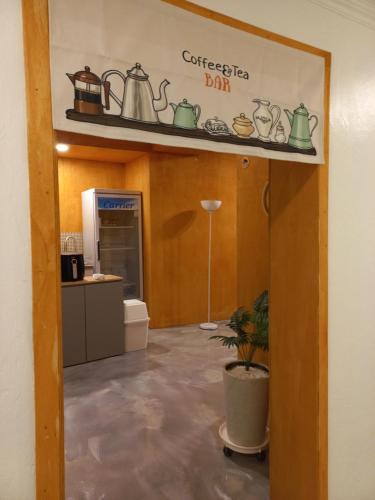 a kitchen with a shelf with pots and pans on it at Air Jinju in Jinju