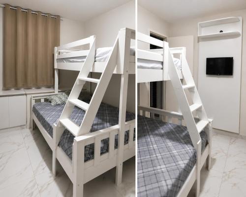 a couple of bunk beds in a room at House Pontal do Paraná in Pontal do Paraná