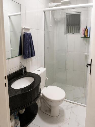 a bathroom with a toilet and a sink and a shower at House Pontal do Paraná in Pontal do Paraná