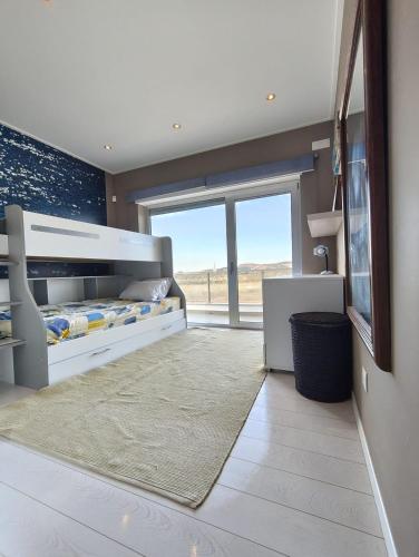 a bedroom with a bed and a large window at Beach Hub in São Martinho do Porto
