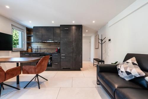 a living room with a couch and a table at CITY-APARTMENT's in Winterthur