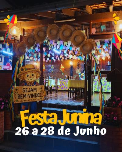 a restaurant with a sign in front of a window at Pousada Luar de Penedo in Penedo