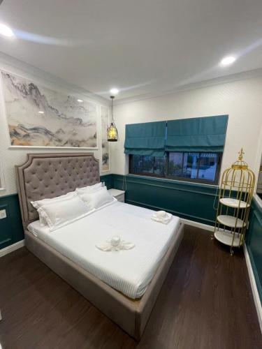 a bedroom with a bed with a chair and a window at Villa Malibu Phan Thiet, Free Parking in Phan Thiet