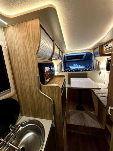 an rv with a sink and a mirror and a sink at Upgrade Beach Resort Infanta Quezon in Infanta