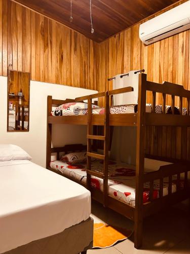 a room with two bunk beds and a bed at Volcano Refuge House in Fortuna