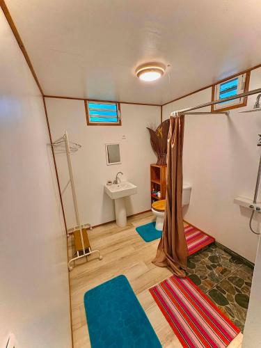 a bathroom with a shower and a sink in a room at Fare Aimeho in Vaianae