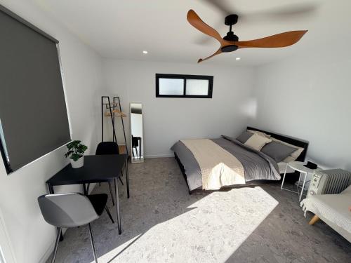 a bedroom with a bed and a ceiling fan at Sydney Studio with Private Bathroom & Kitchen in Revesby
