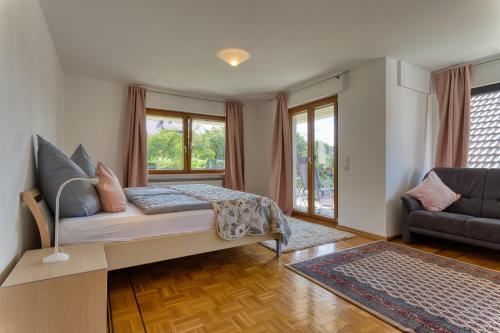 a living room with a bed and a couch at Nanas-Auszeit in Rothenbuch