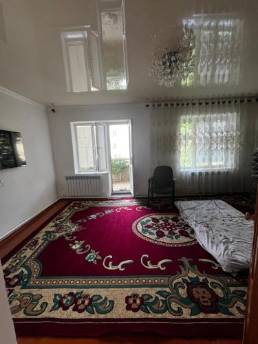 a bedroom with a bed and a large rug at Aida in Tebykty