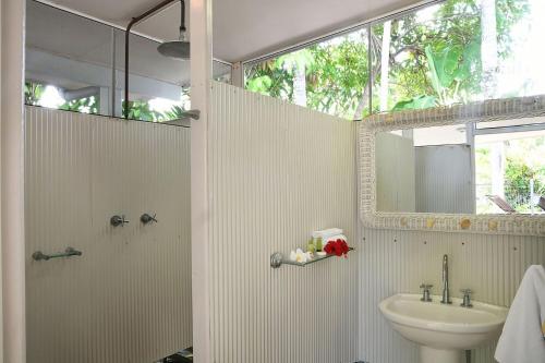 a bathroom with a sink and a toilet and a mirror at Seasons at South Mission Beach in South Mission Beach
