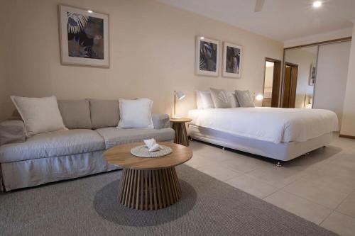 a living room with a bed and a couch at Latitude 17 Suite 2 in South Mission Beach
