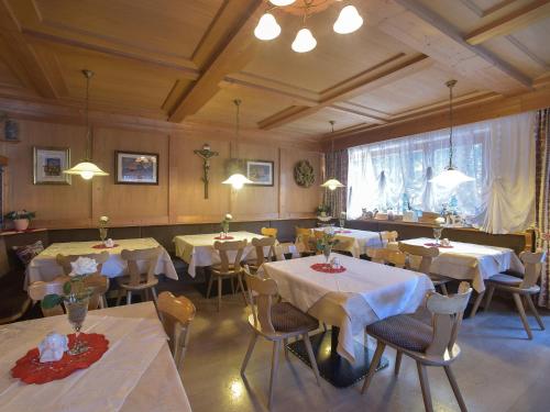a restaurant with tables and chairs with white table cloth at Pension Atlantic in Badia