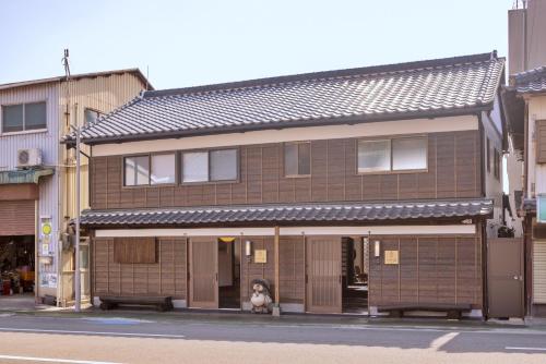 a dog sitting in the window of a building at Ocean Living LA FUKU 和歌浦 一棟貸し 愛犬と泊まれる海辺の宿 in Wakayama