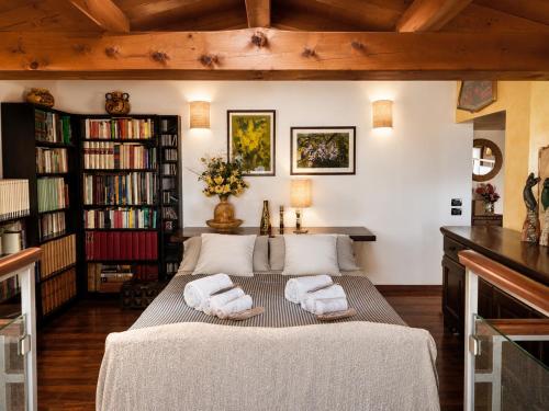 a room with a bed with towels on it at Sunshine Luxury Apartment - spacious house - Lake View - Pool in Padenghe sul Garda