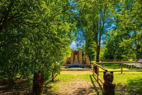 a teddy bear standing in front of a fountain at Tenuta Di Litiano Villa with Garden and Pool - Happy Rentals in Roccastrada