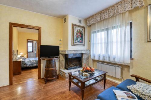 a living room with a couch and a fireplace at Tenuta Di Litiano Villa with Garden and Pool - Happy Rentals in Roccastrada