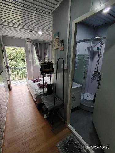 a bedroom with a mirror and a bed and a tub at DMaro Cabin in Kampong Kundassan