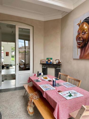 a dining room with a table with a mask on the wall at Elegant Manor House in Tongeren
