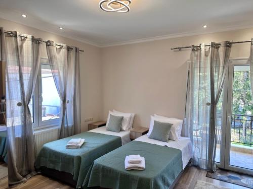 a bedroom with two beds and a window at MoSta Sunset in Litochoro