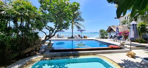 a swimming pool with a view of the ocean at Papillon Resort in Chaweng