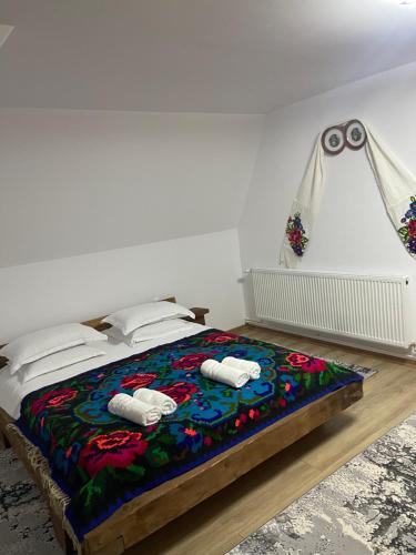 a bedroom with a bed with two towels on it at Casa Moroseneasca Breb in Breb