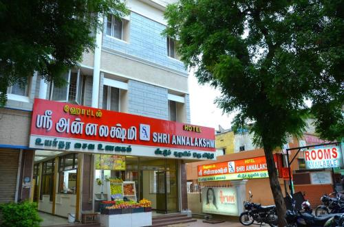 a group of shops on a city street at Hotel shri annalakshmi lodge in Theni