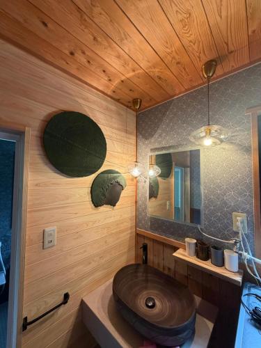 a bathroom with a wooden sink and a mirror at 森権太 Forest Gonta in Takamori