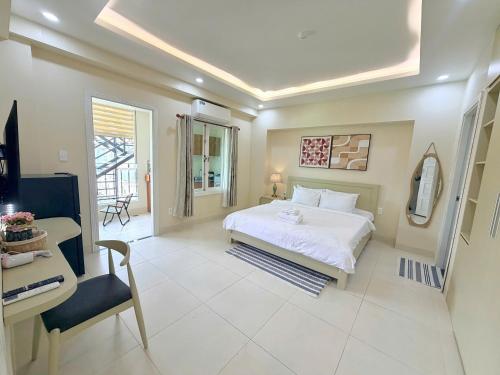 a bedroom with a bed and a desk and a chair at Huko House in Ho Chi Minh City