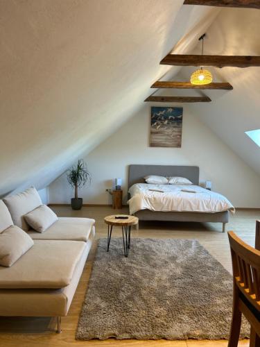 a living room with a bed and a couch at WILLOW in Pāvilosta