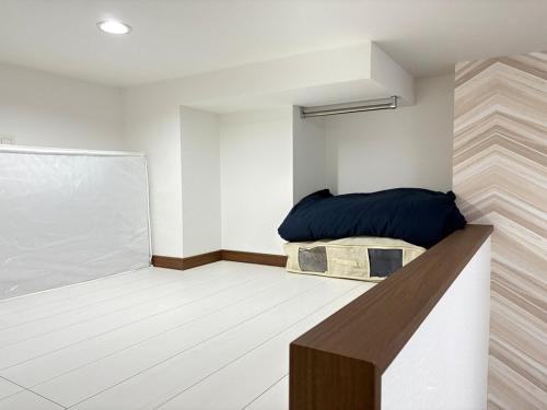 a small room with a bed in the corner at The Scene Fuchinobe in Sagamihara