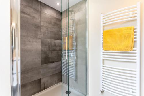 a shower with a glass door in a bathroom at Une Chambre À Lestriguiou in Plomeur