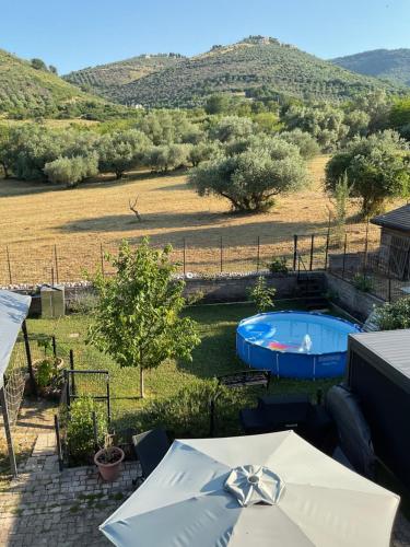 a patio with a hot tub in a field with trees at Il Posto delle Rose 1 in San Polo dei Cavalieri
