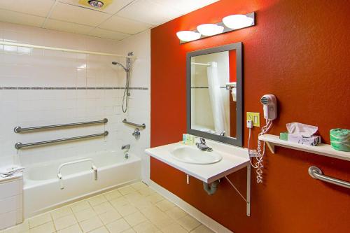 a bathroom with a sink and a shower and a mirror at Quality Inn Plainfield I-395 in Plainfield