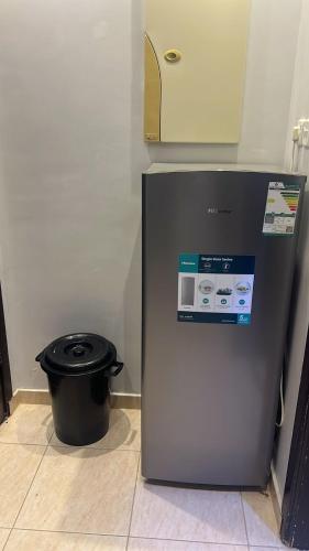 a small refrigerator in a room with a trash can at لافندر الطائف 2 in Taif