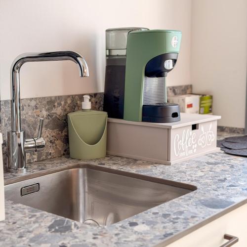 a kitchen counter with a mixer and a sink at Cà in Laguna in Chioggia